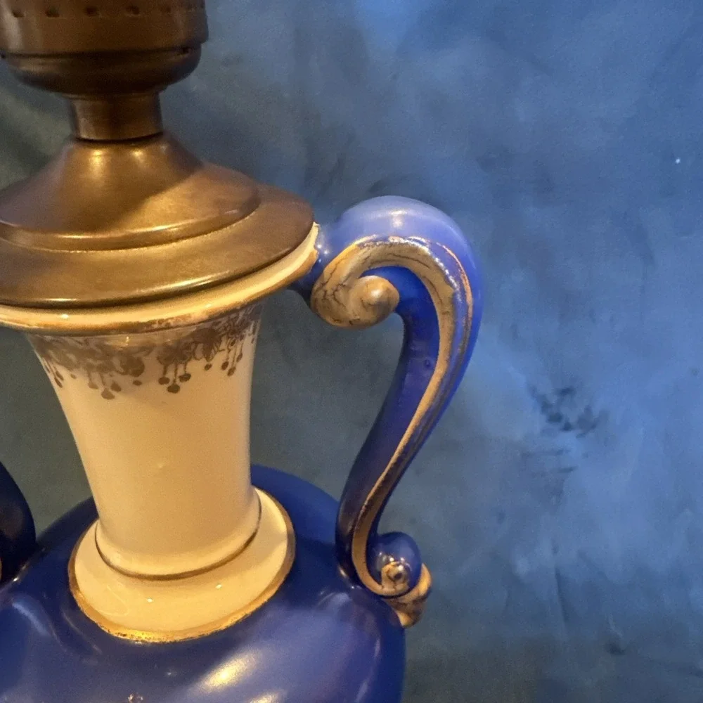 Antique porcelain urn lamp with grape-picking scene.